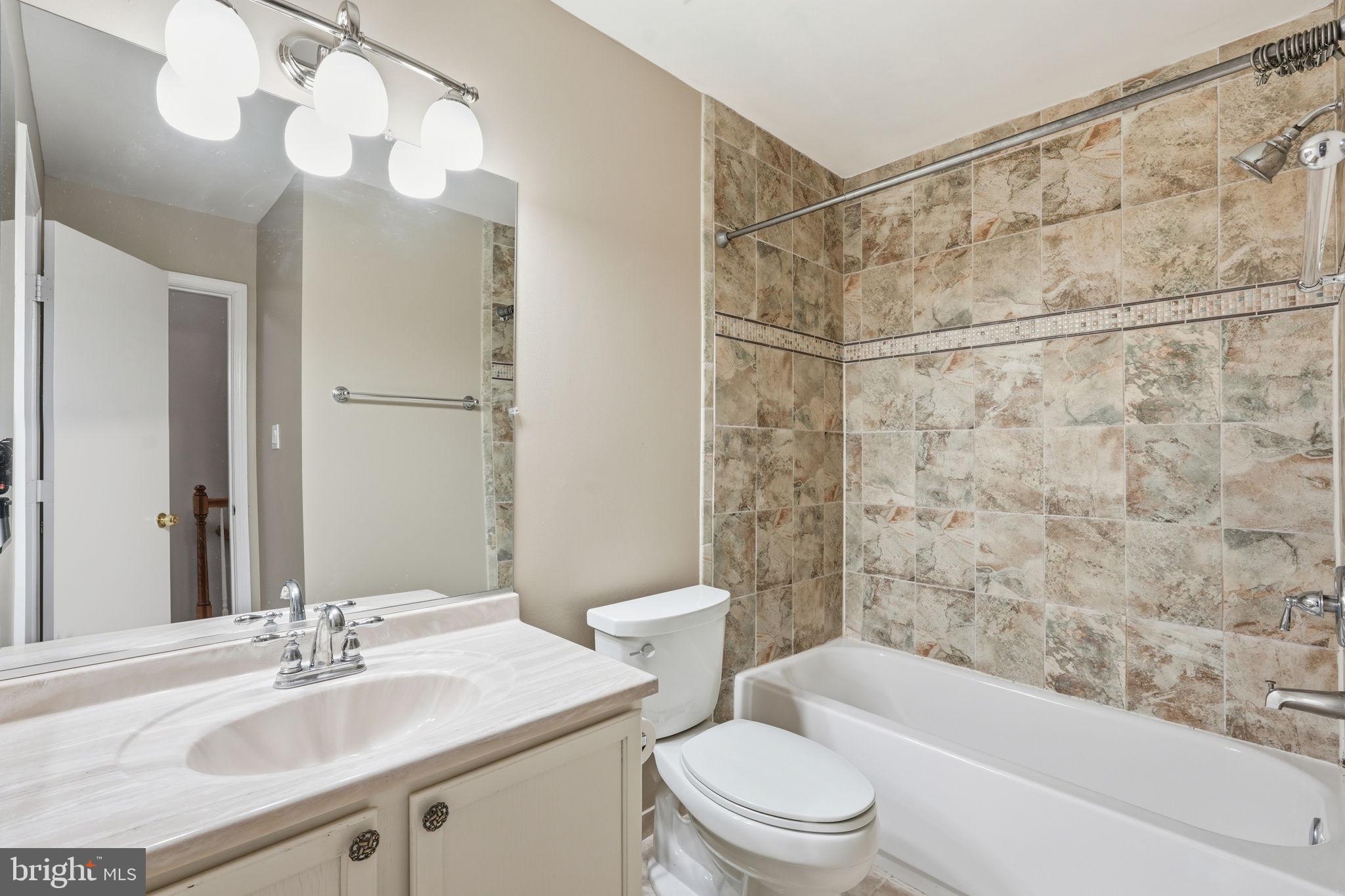 8074 Sebon Drive Vienna, VA 22180 - Photo 17 of 22 a bathroom with a sink toilet and shower