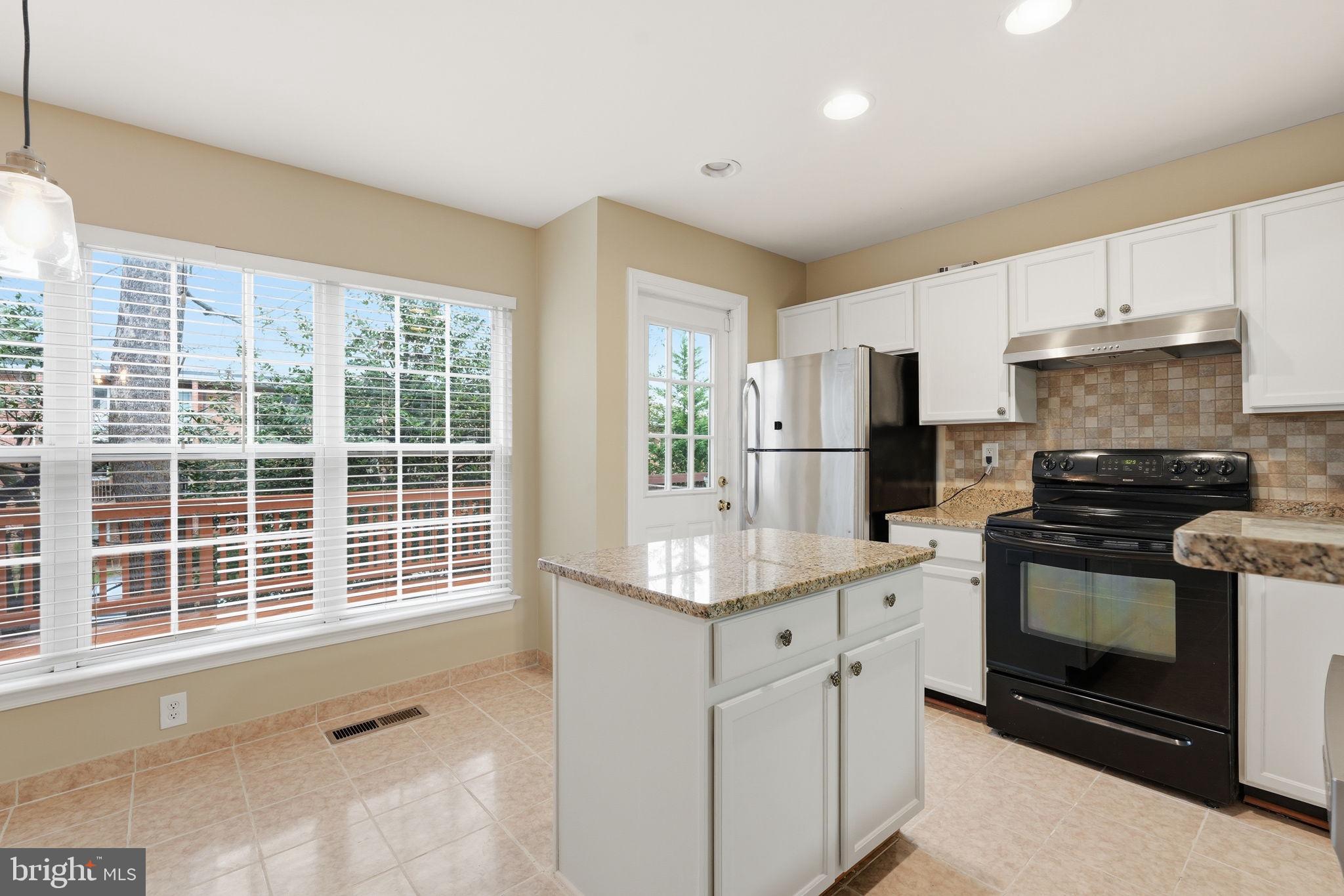 8074 Sebon Drive Vienna, VA 22180 - Photo 5 of 22 a kitchen with stainless steel appliances granite countertop a stove a sink and a refrigerator
