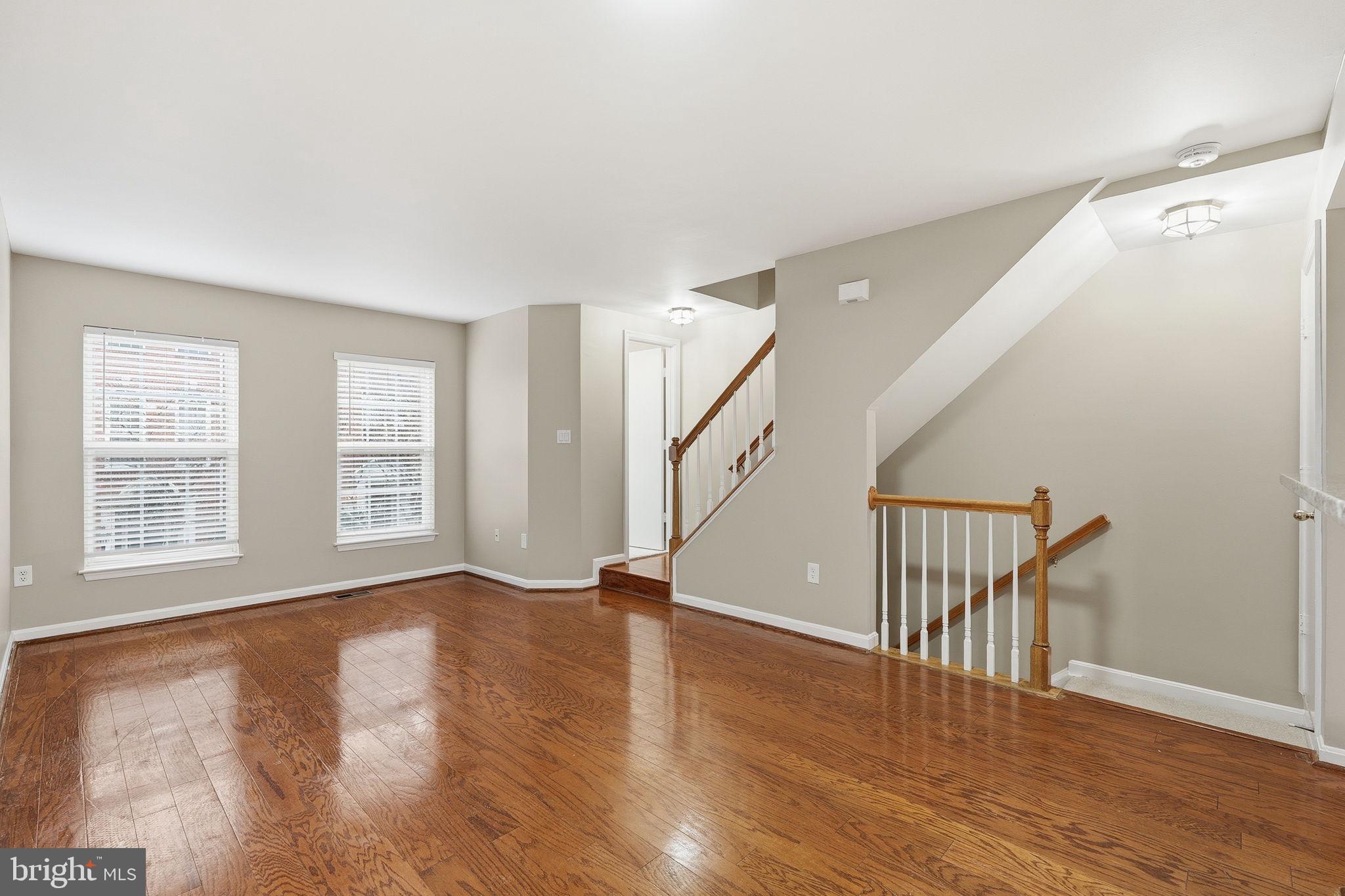 8074 Sebon Drive Vienna, VA 22180 - Photo 7 of 22 a view of an empty room with wooden floor and a window