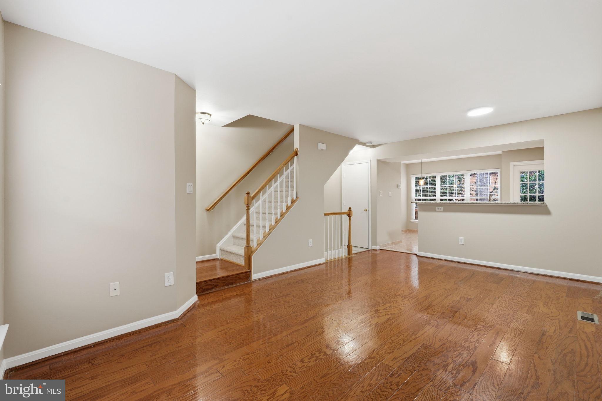 8074 Sebon Drive Vienna, VA 22180 - Photo 8 of 22 a view of an empty room with wooden floor and stairs