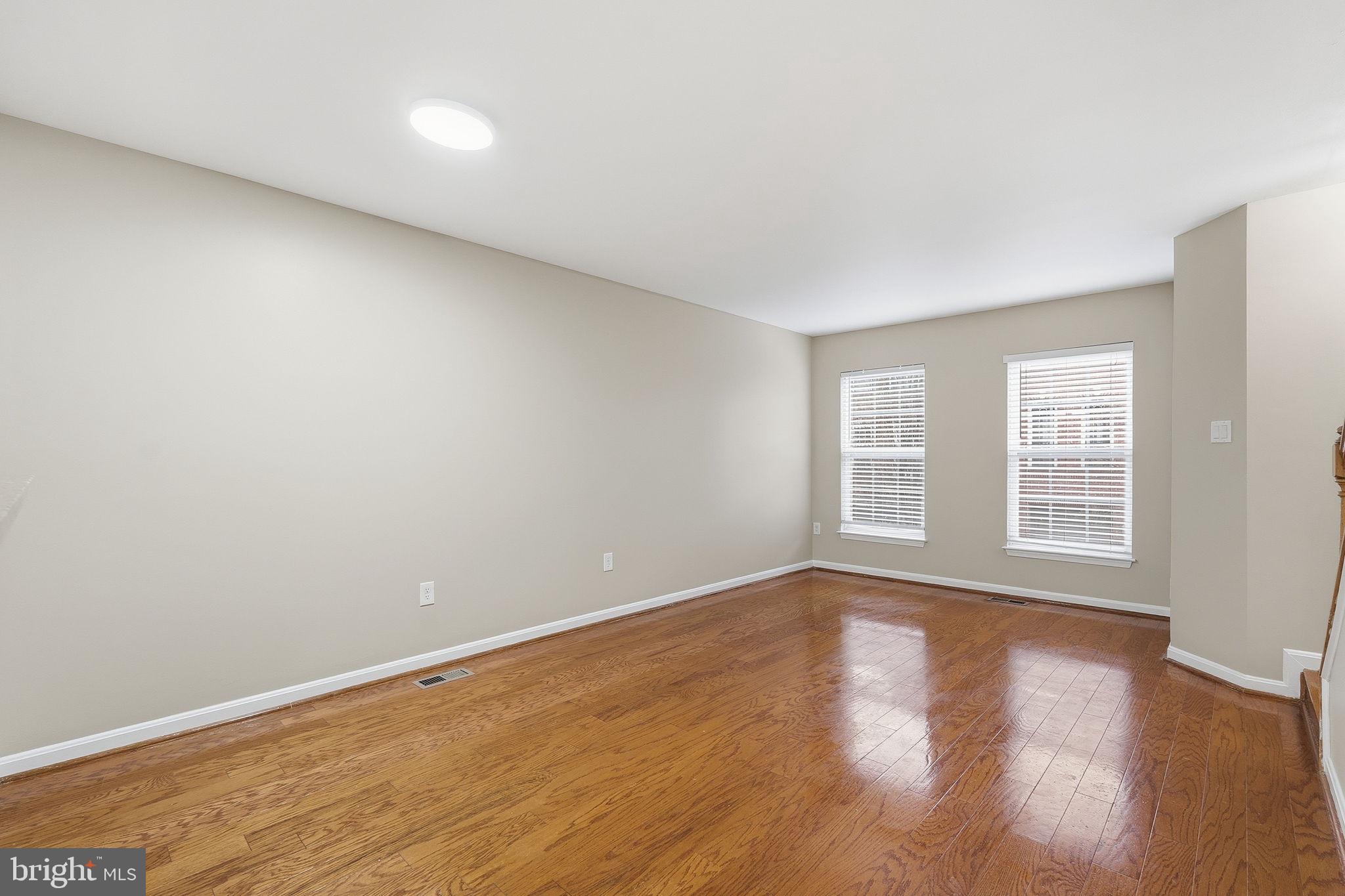 8074 Sebon Drive Vienna, VA 22180 - Photo 9 of 22 a view of an empty room with wooden floor and a window