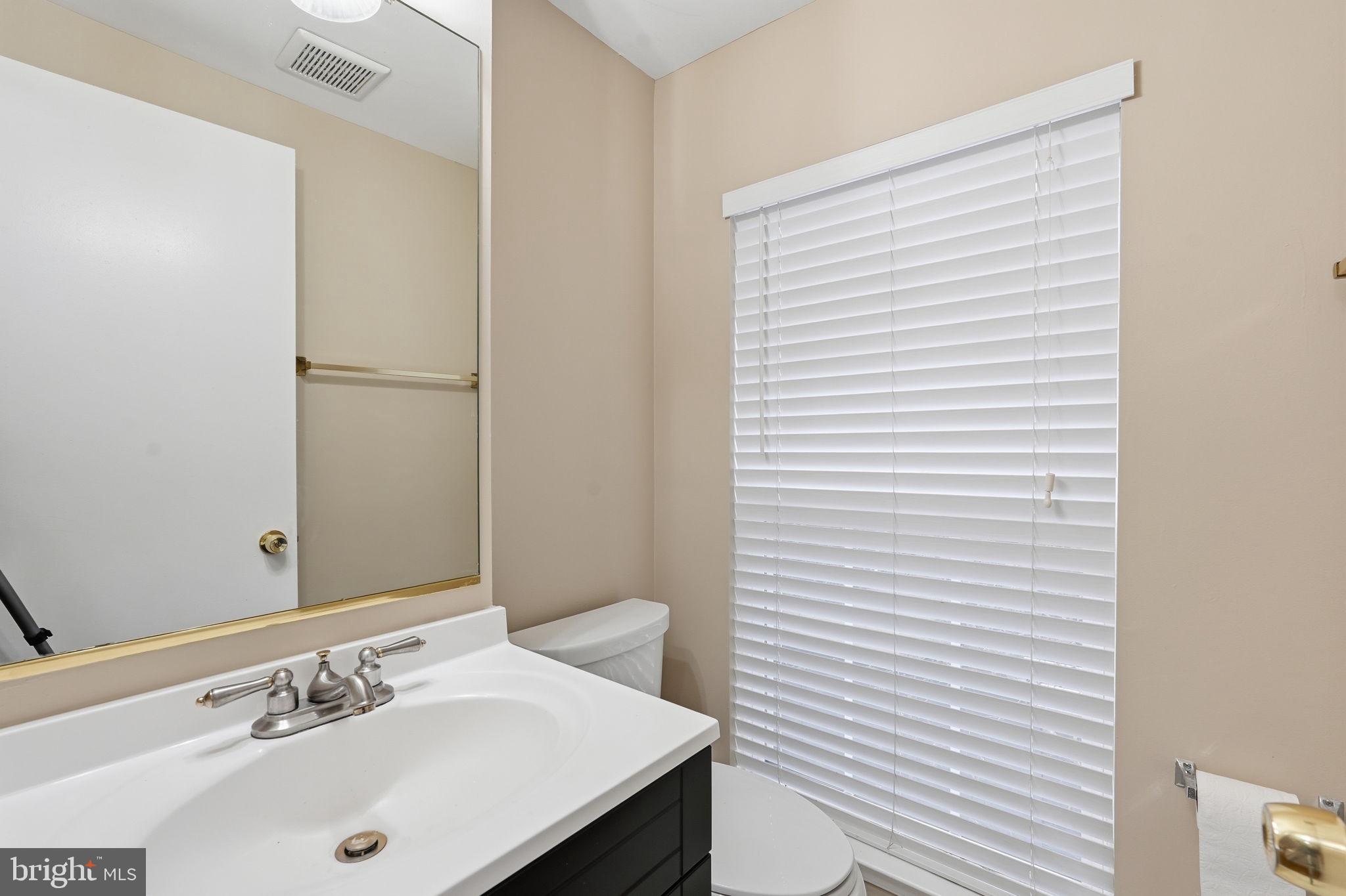8074 Sebon Drive Vienna, VA 22180 - Photo 10 of 22 a bathroom with a sink and a mirror