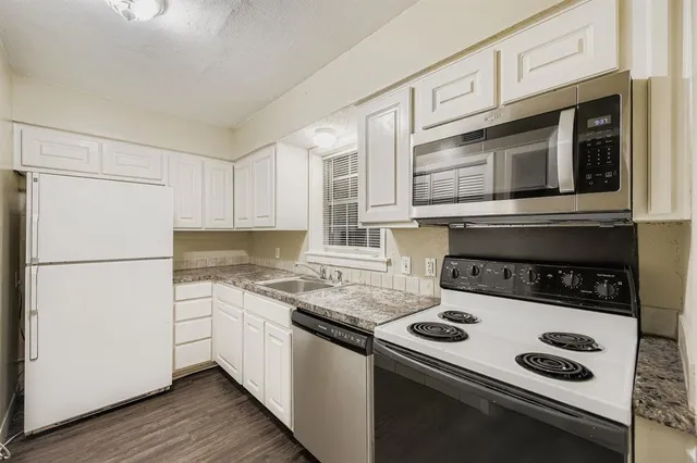 a kitchen with a stove and a refrigerator