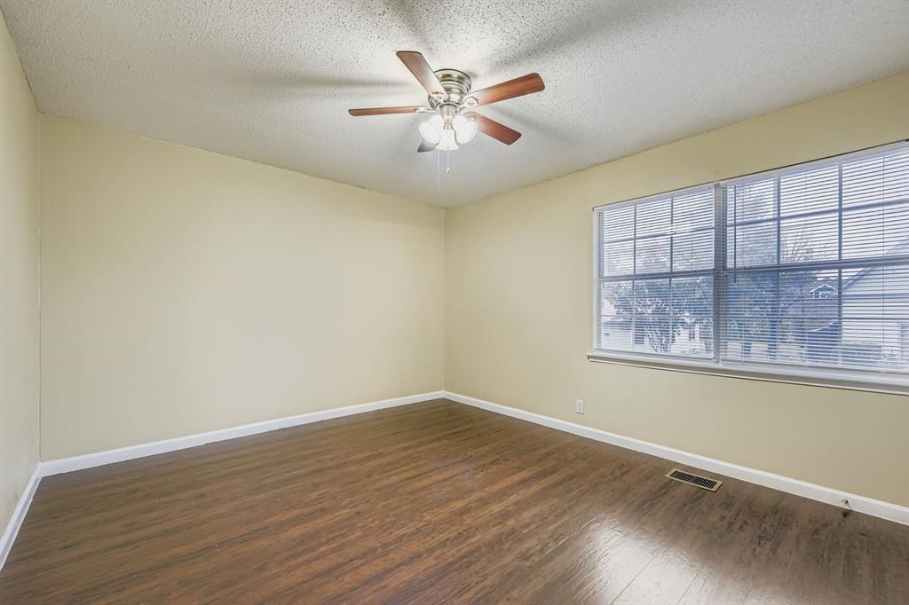 214 Austin Street Grapevine, TX 76051 - Photo 13 of 28 wooden floor in an empty room with a window