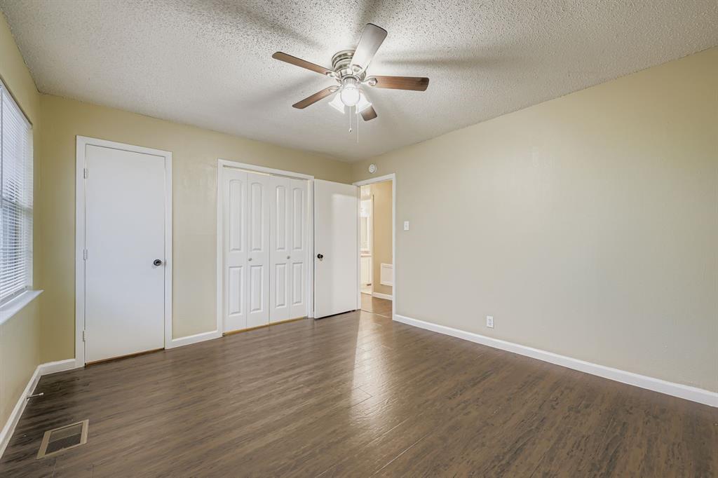 214 Austin Street Grapevine, TX 76051 - Photo 15 of 28 a view of an empty room with window and wooden floor