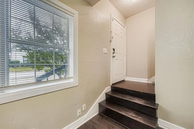a view of outdoor space with wooden floor and windows
