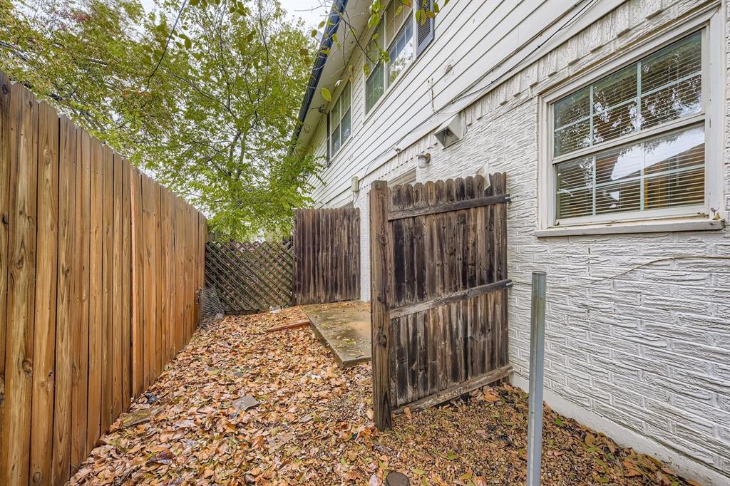214 Austin Street Grapevine, TX 76051 - Photo 24 of 28 a view of a pathway of a house with wooden fence