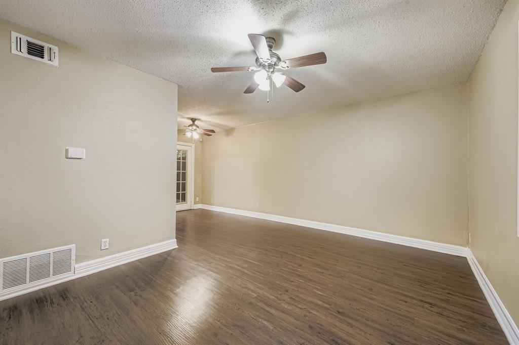 214 Austin Street Grapevine, TX 76051 - Photo 6 of 28 wooden floor in an empty room with a window