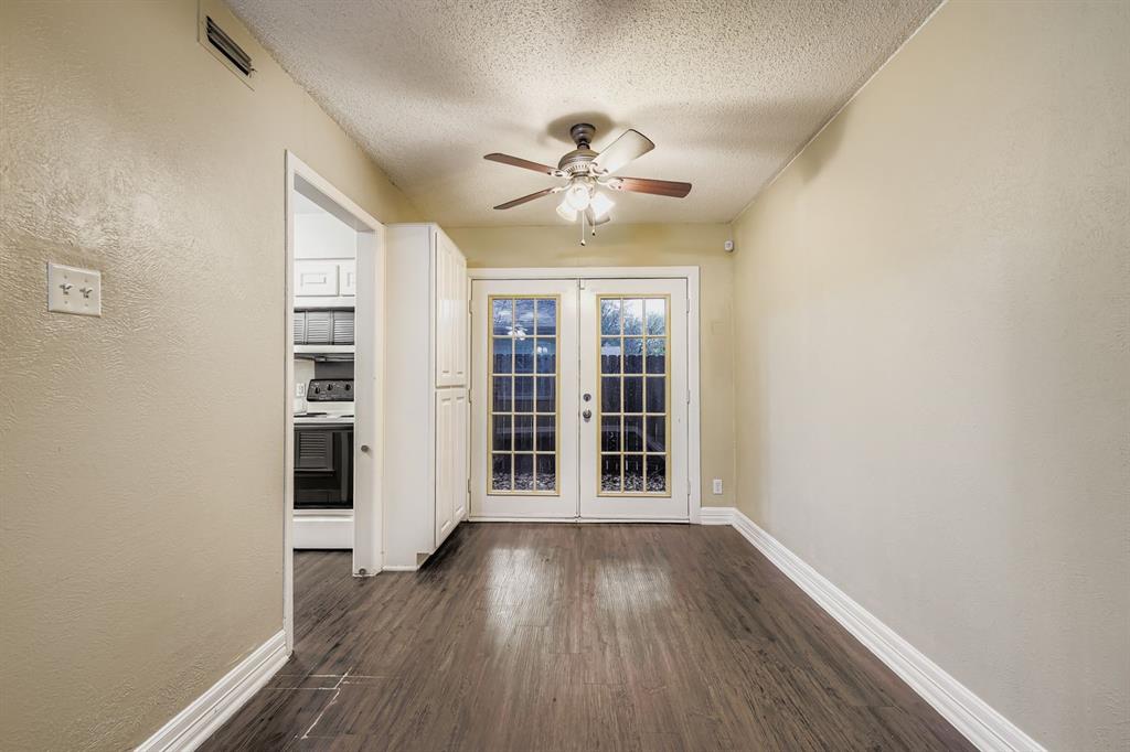 214 Austin Street Grapevine, TX 76051 - Photo 9 of 28 an empty room with wooden floor and windows