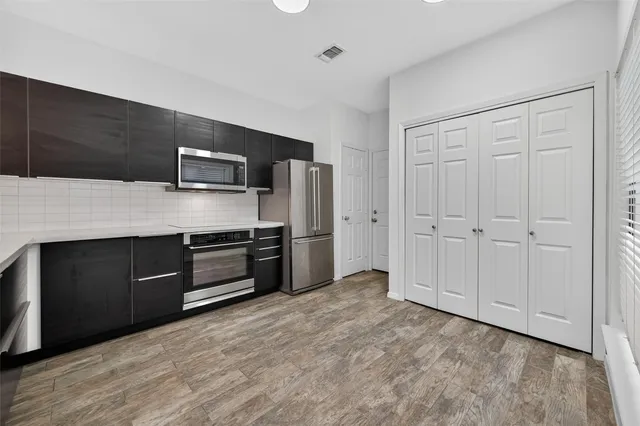 a kitchen with a refrigerator and a sink
