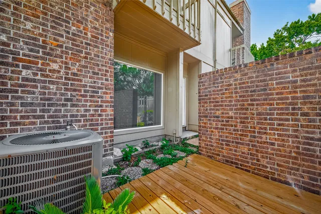 a view of brick house with a yard