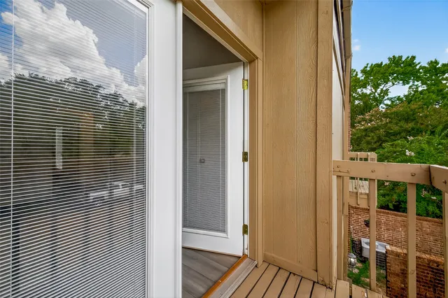 a view of a door with a glass door and a window