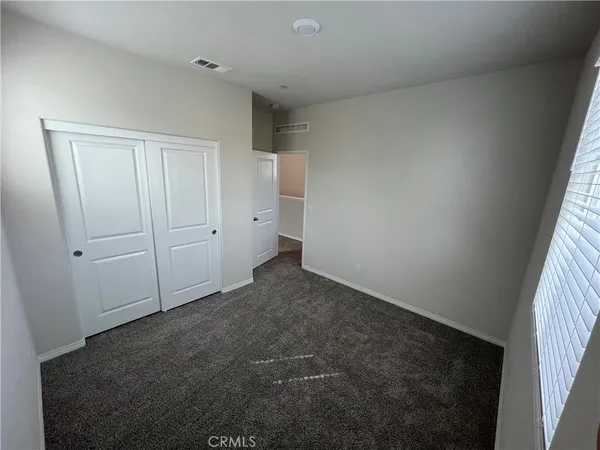 an empty room with closet area