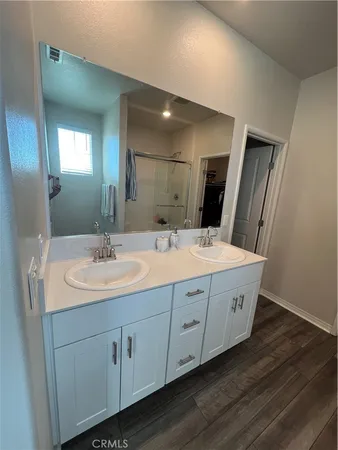 a bathroom with a double vanity sink and a mirror