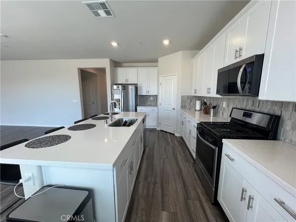 a kitchen with a sink a stove and refrigerator