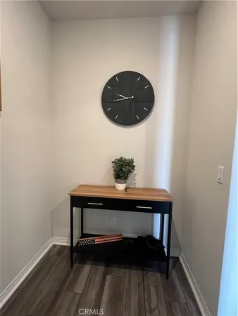 a view of a small space with wooden floor and a potted plant