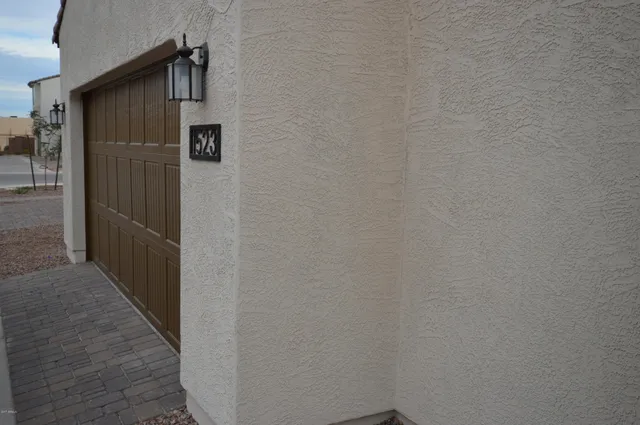 a view of a house with a door and wooden wall