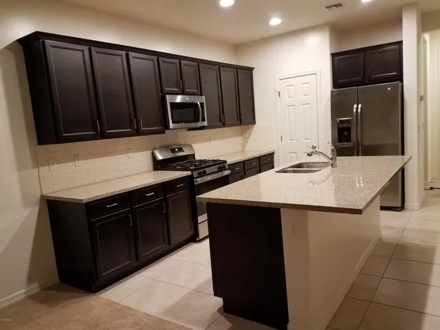 a kitchen with a sink and a refrigerator