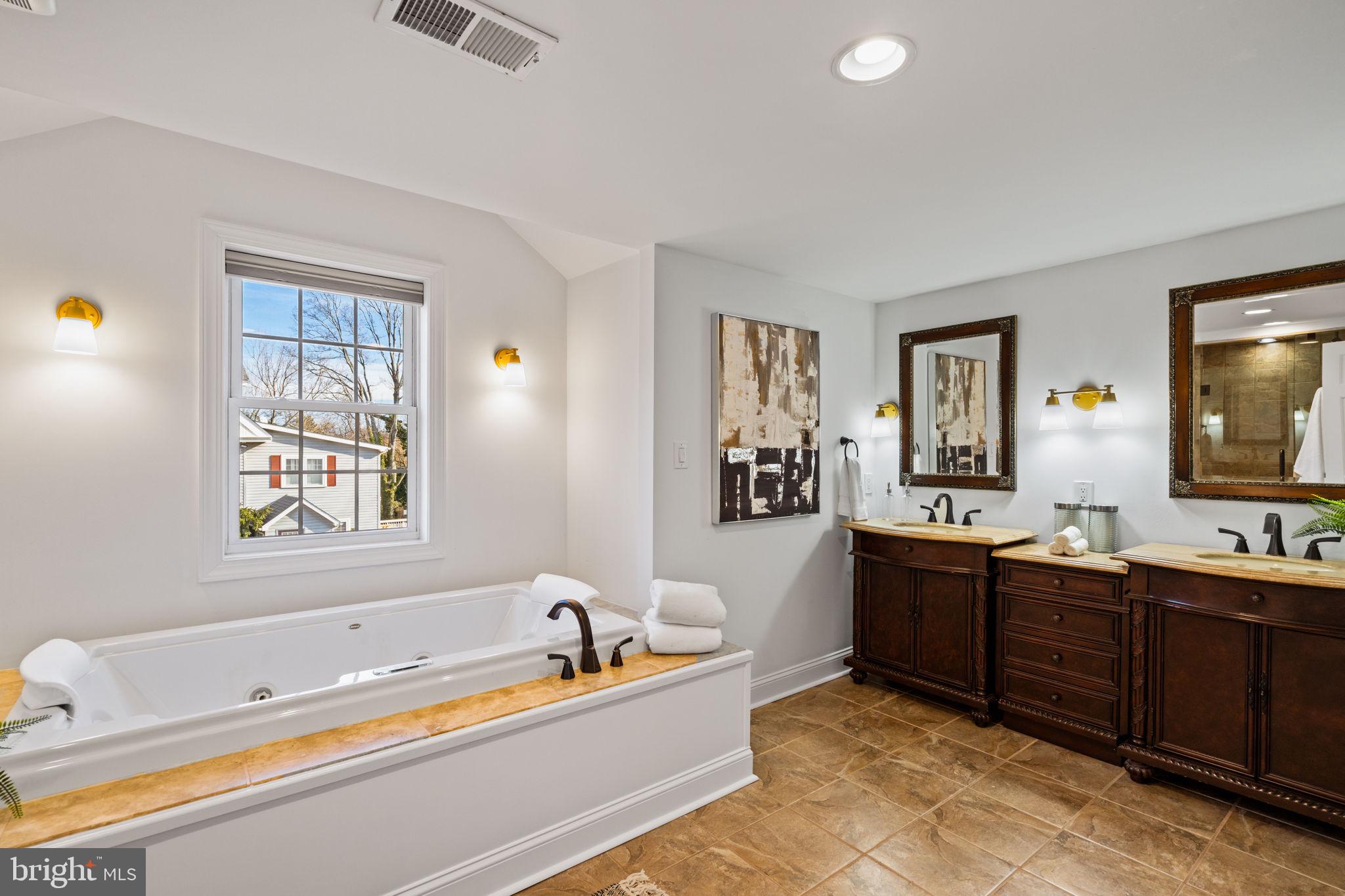 727 East Manoa Road Havertown, PA 19083 - Photo 35 of 68 a spacious bathroom with a tub a double sink and a mirror