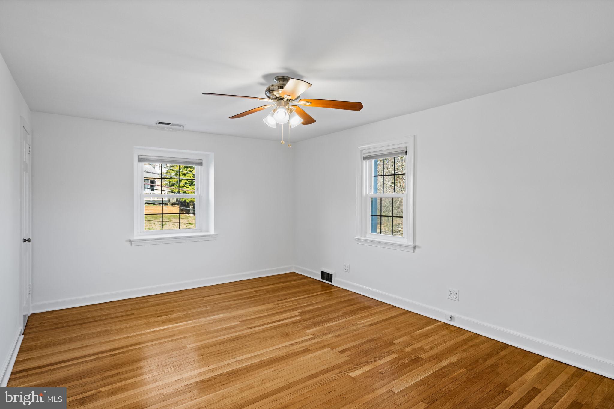 727 East Manoa Road Havertown, PA 19083 - Photo 42 of 68 a view of an empty room with window and ceiling fan