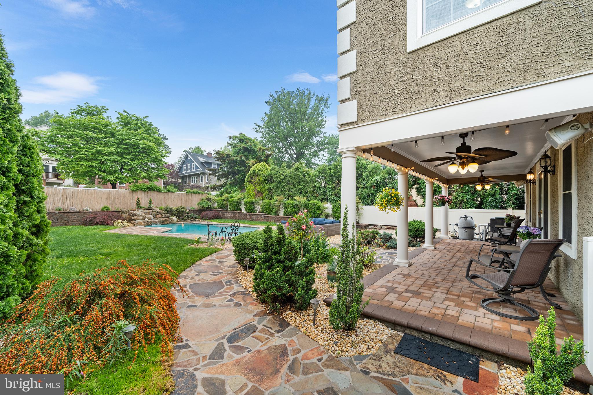 727 East Manoa Road Havertown, PA 19083 - Photo 56 of 68 a view of a patio with table and chairs potted plants and floor to ceiling window