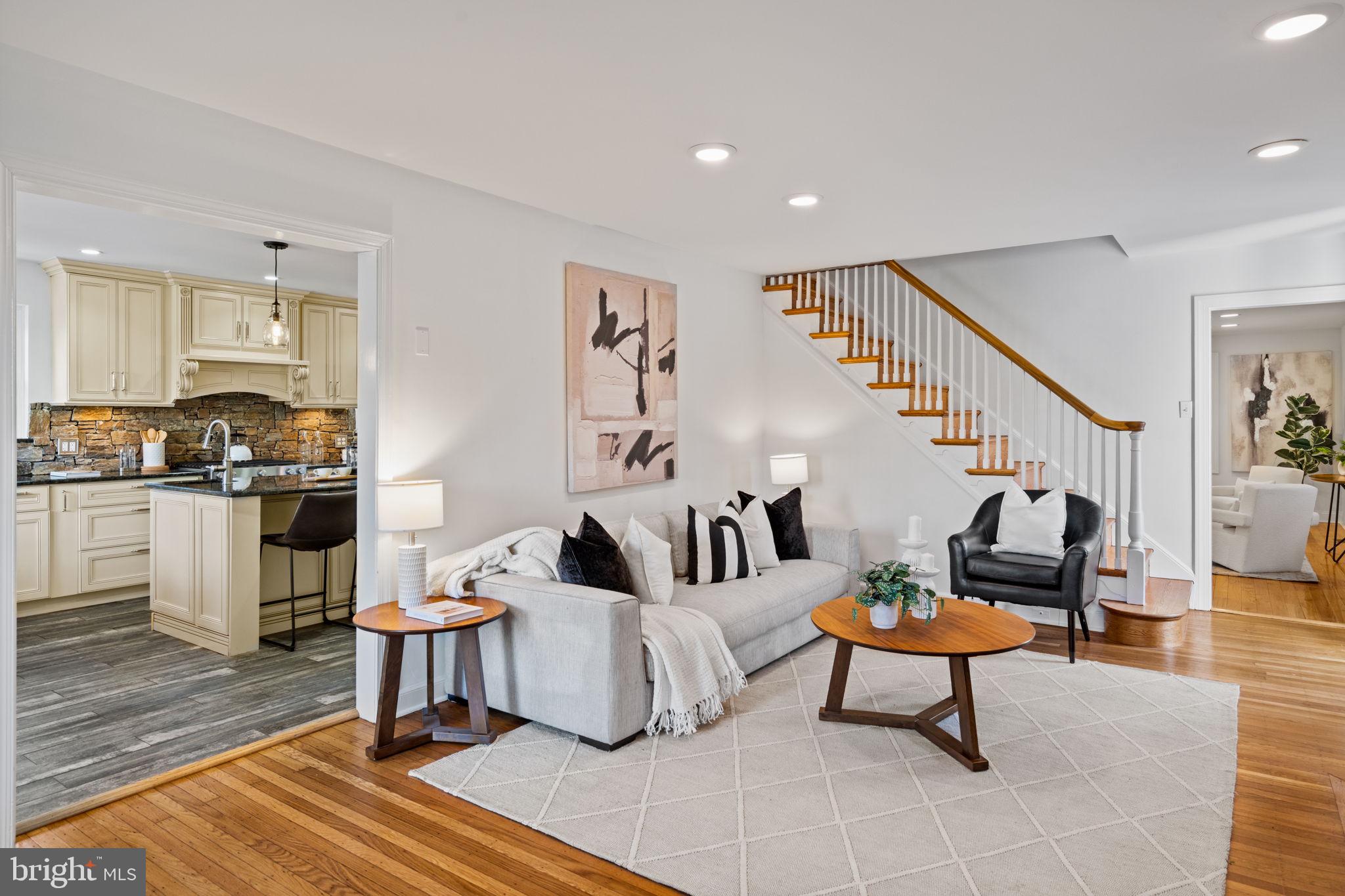 727 East Manoa Road Havertown, PA 19083 - Photo 7 of 68 a living room with furniture and a dining table with wooden floor