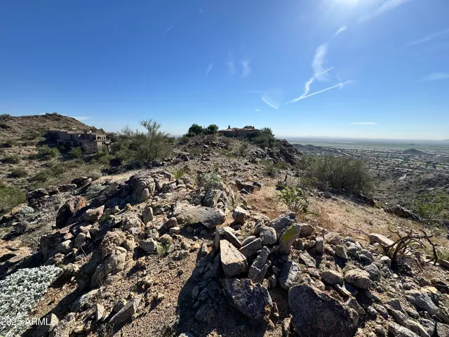 an aerial view of a residential houses with city view