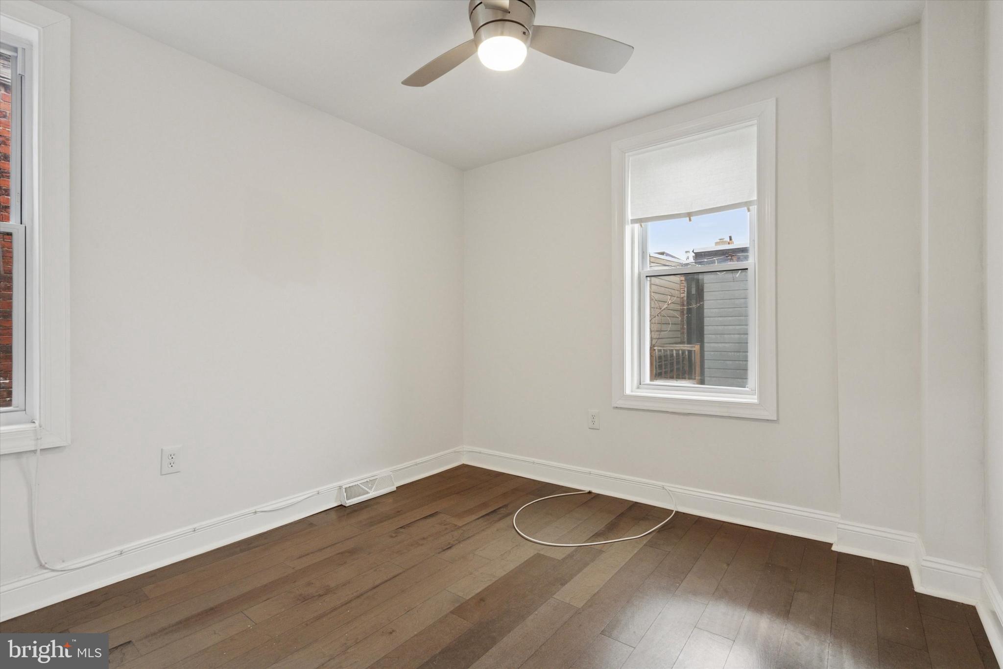 5121 Hadfield Street Philadelphia, PA 19143 - Photo 12 of 19 an empty room with wooden floor and windows
