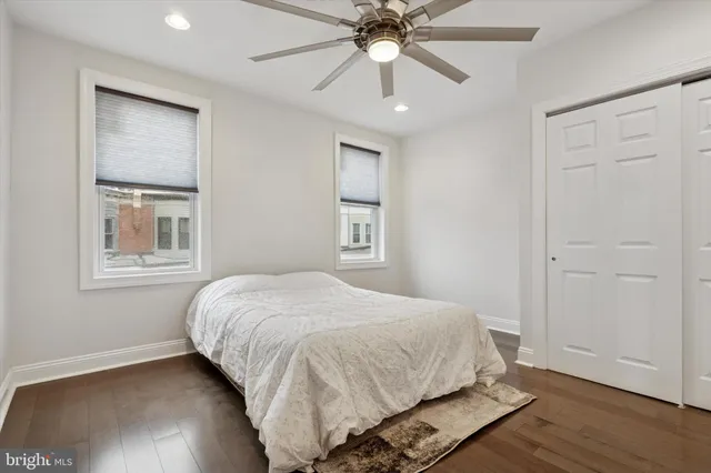 a bedroom with a large bed and a window