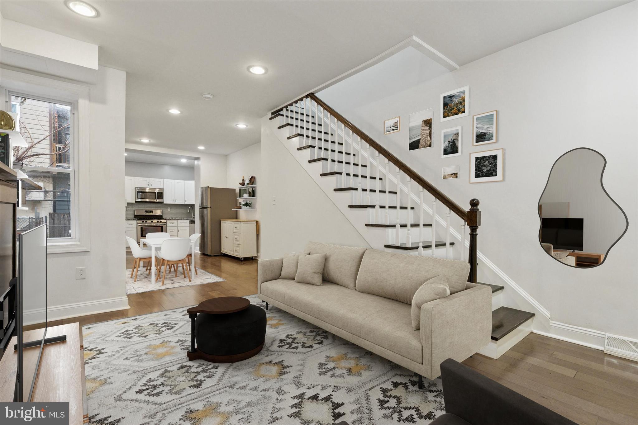 5121 Hadfield Street Philadelphia, PA 19143 - Photo 7 of 19 a living room with furniture or wooden floor and a chandelier