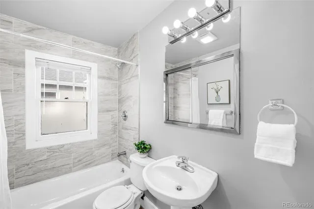 a bathroom with a toilet a sink and a bathtub