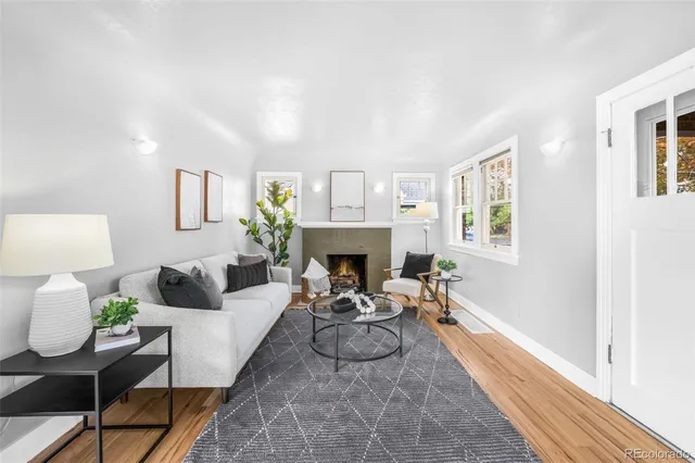 a living room with furniture a fireplace and a table
