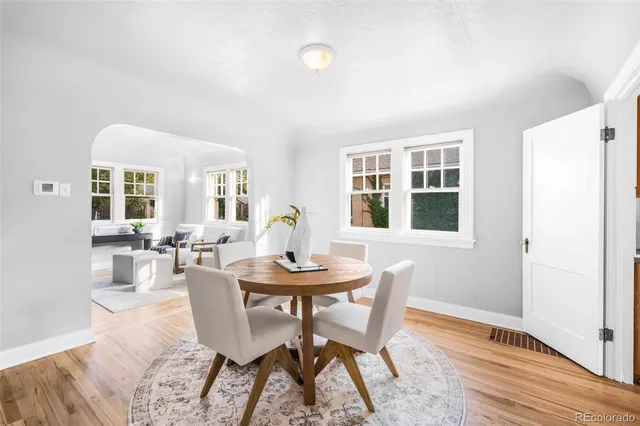 a dining room with furniture and window