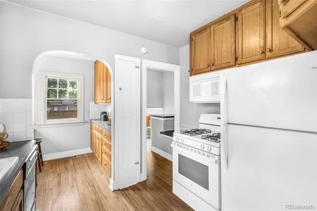 a kitchen with a refrigerator and a stove top oven