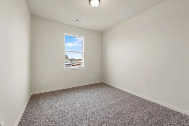 a view of a kitchen with a sink a kitchen counter top space stainless steel appliances and a window