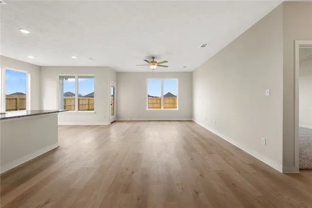 a view of kitchen with stainless steel appliances granite countertop a stove top oven a sink and a microwave