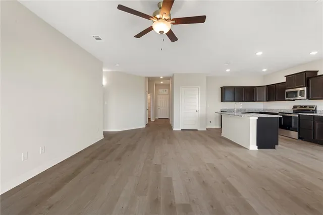 a kitchen with stainless steel appliances granite countertop a stove a sink and a refrigerator