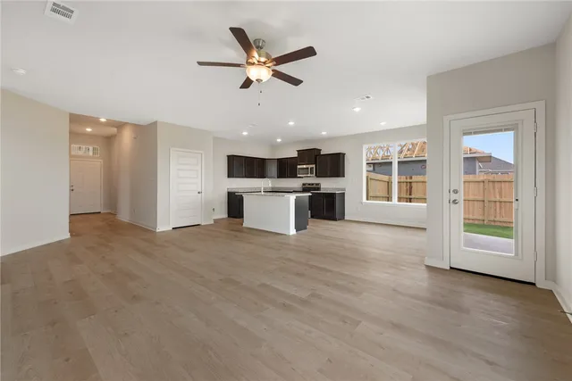 a kitchen with stainless steel appliances granite countertop a sink a stove and cabinets