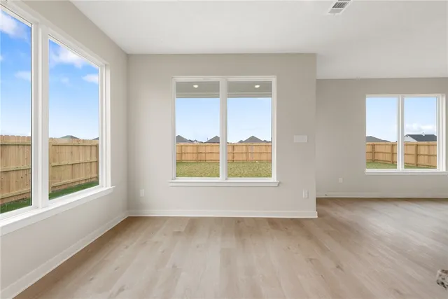 a view of a big room with windows and chandelier fan