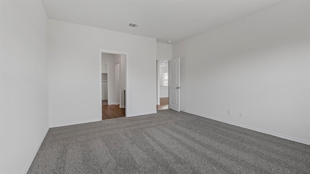 212 Pheasant Run Road Terrell, TX 75160 - Photo 17 of 24 Spacious room featuring gray carpeting, white painted walls, and white trim