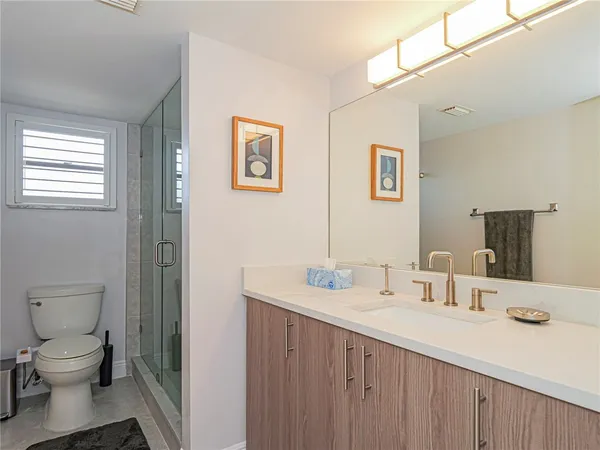 a bathroom with a sink toilet and a mirror
