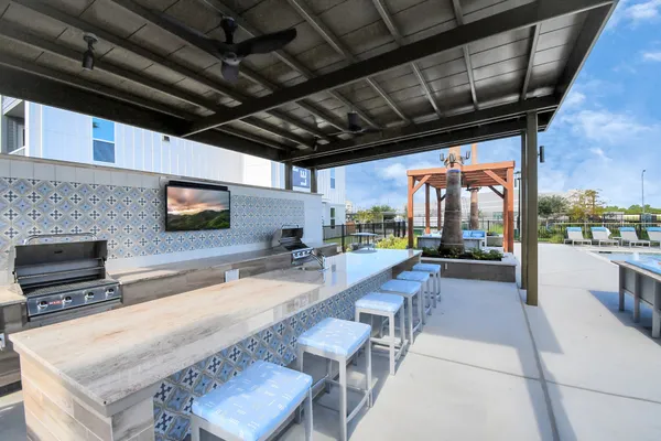 a swimming pool with outdoor seating and yard