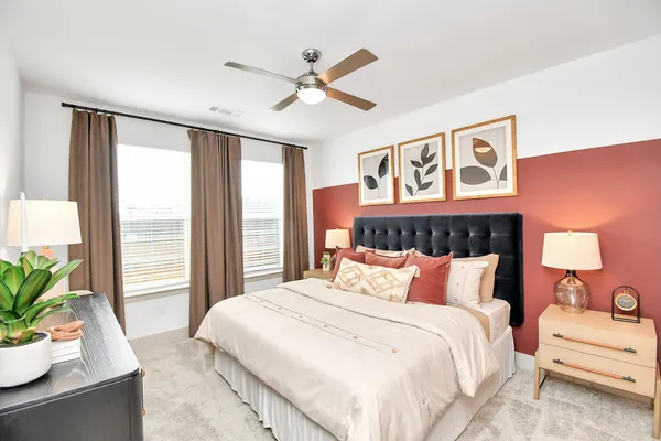 a bedroom with a large bed and a window