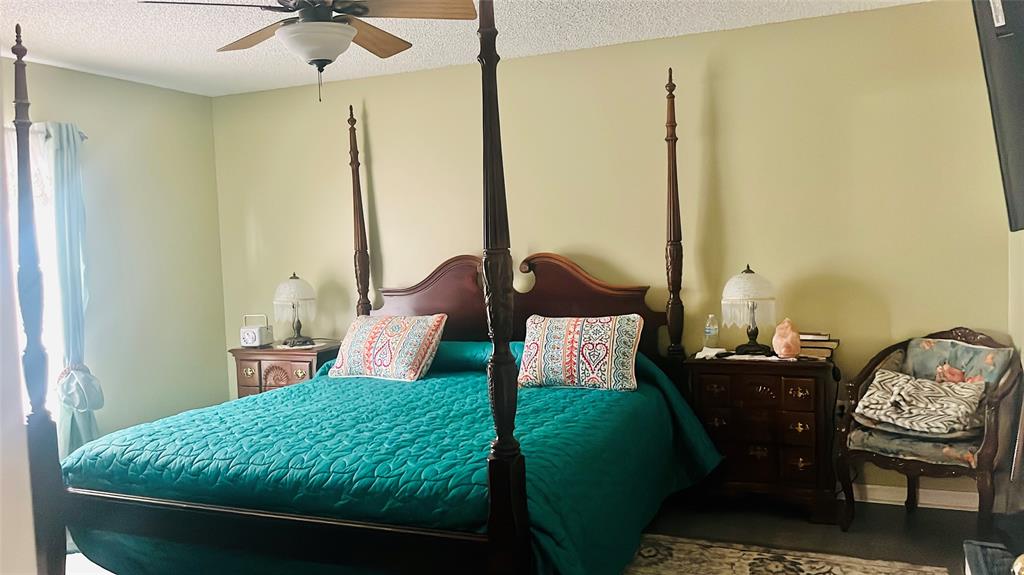 184 Massini Avenue Northwest Palm Bay, FL 32907 - Photo 14 of 15 a bedroom with a bed window and lamp