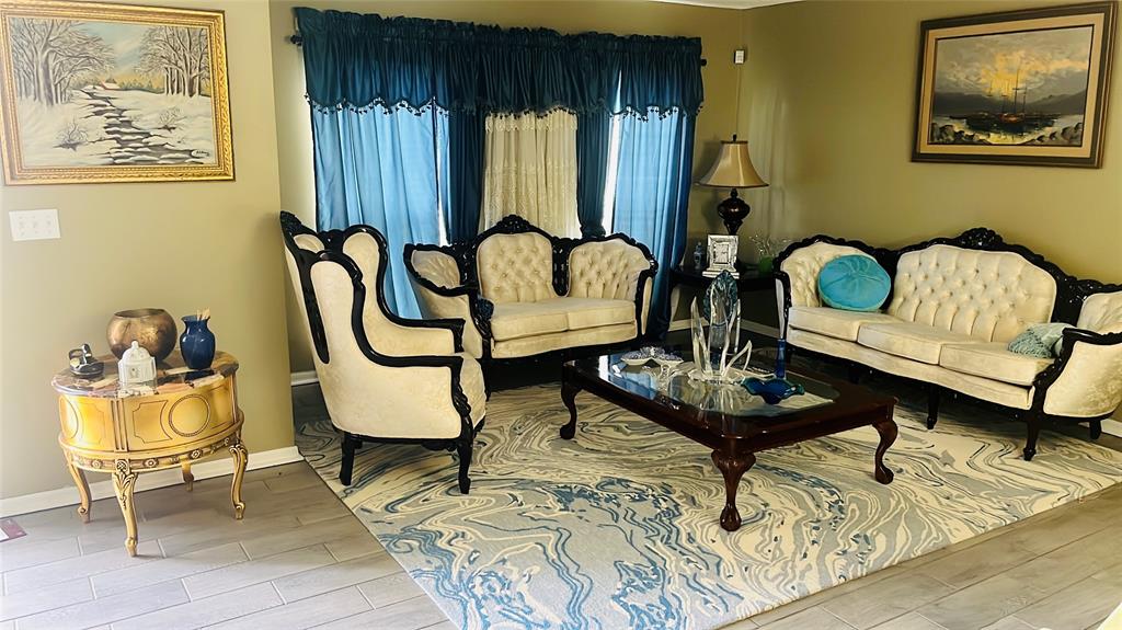 184 Massini Avenue Northwest Palm Bay, FL 32907 - Photo 4 of 15 a living room with furniture and a painting on the wall