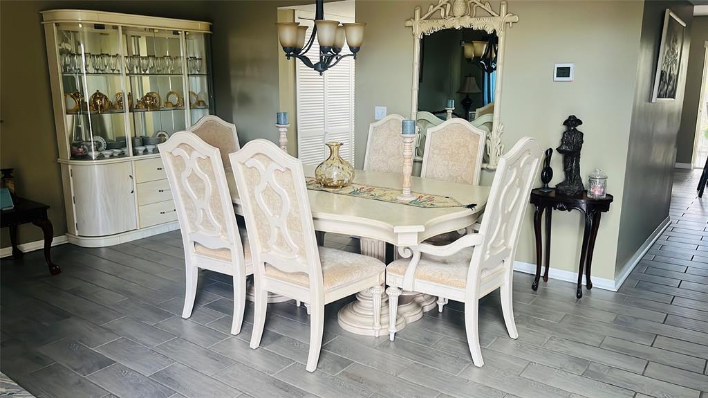 184 Massini Avenue Northwest Palm Bay, FL 32907 - Photo 5 of 15 a view of a dining room with furniture and wooden floor