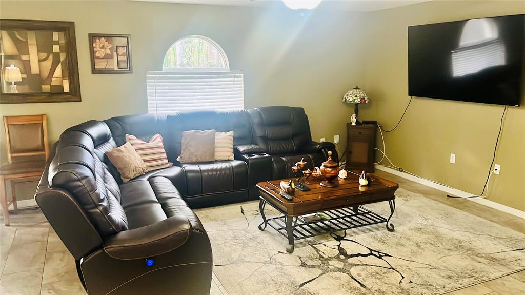 184 Massini Avenue Northwest Palm Bay, FL 32907 - Photo 6 of 15 a living room with furniture and a flat screen tv