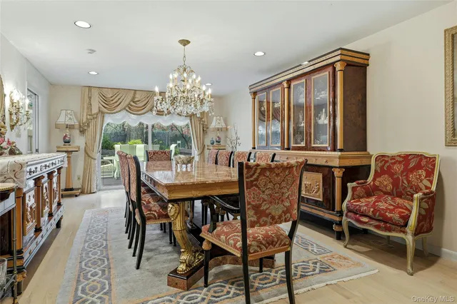 a view of a dining room with furniture and a chandelier
