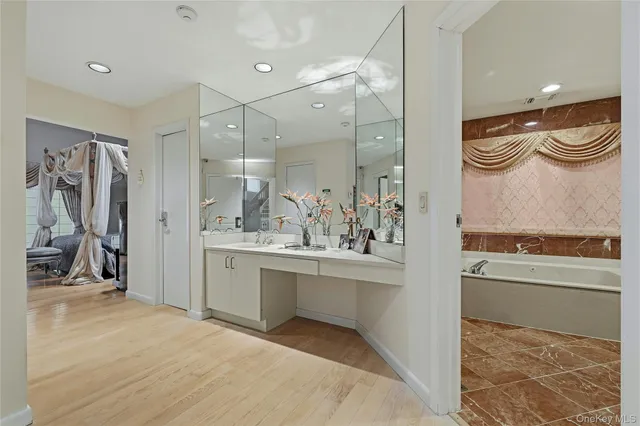 a bathroom with a bathtub sink and mirror