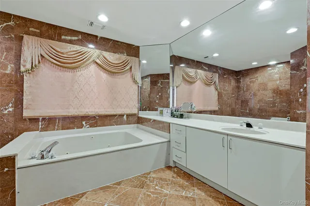 a bathroom with a bathtub and a sink